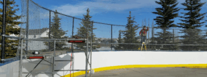 Outdoor hockey rink under construction with scaffolding.