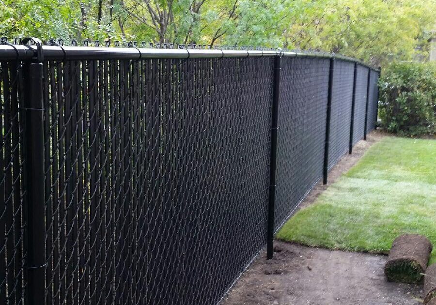 20170918_121513 A long black chain-link fence along a garden path.